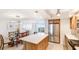 Open-concept kitchen and dining area featuring a stylish table and seating for six with a large island at 1212 Benjamin Franklin Dr # 909, Sarasota, FL 34236