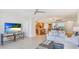 Bright living room with comfortable seating, open to the kitchen and dining area, with tile flooring throughout at 1212 Benjamin Franklin Dr # 909, Sarasota, FL 34236