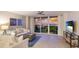 Cozy living room with water views, balcony access, coastal decor, comfortable seating, and ample natural light at 1212 Benjamin Franklin Dr # 909, Sarasota, FL 34236