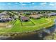 Aerial view of a single Gathering home featuring a fenced backyard, and a serene pond at 12815 24Th Street E Cir, Parrish, FL 34219