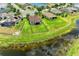 Aerial view featuring a backyard with a black metal fence adjacent to a tranquil pond at 12815 24Th Street E Cir, Parrish, FL 34219