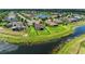 Aerial view showcases the backyard with black metal fence and serene pond view of the property at 12815 24Th Street E Cir, Parrish, FL 34219