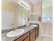 Bathroom featuring double sinks, granite countertops, and framed mirrors at 12815 24Th Street E Cir, Parrish, FL 34219