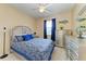 Bedroom featuring ceiling fan, carpeting, and window with blue curtains at 12815 24Th Street E Cir, Parrish, FL 34219
