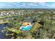 Beautiful aerial view of community pool, tennis courts, and surrounding homes at 12815 24Th Street E Cir, Parrish, FL 34219