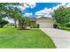 Charming single-Gathering home boasts a lush lawn and mature trees, providing great curb appeal at 12815 24Th Street E Cir, Parrish, FL 34219