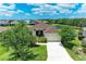 Aerial view of a single Gathering home featuring a well-manicured lawn, mature landscaping, and a serene pond at 12815 24Th Street E Cir, Parrish, FL 34219