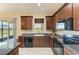 Eat-in kitchen featuring stainless appliances, granite countertops, and sliding door access to the backyard at 12815 24Th Street E Cir, Parrish, FL 34219