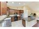 Modern kitchen with stainless steel appliances, wooden cabinetry, granite countertops, and island with seating at 12815 24Th Street E Cir, Parrish, FL 34219