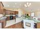 Open eat-in kitchen with tile floor, wood cabinets, granite counters and stainless appliances at 12815 24Th Street E Cir, Parrish, FL 34219