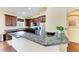 Kitchen boasts granite counters, dark cabinets, stainless steel appliances, and a breakfast bar at 12815 24Th Street E Cir, Parrish, FL 34219