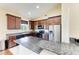 Updated kitchen features stainless steel appliances, a breakfast bar, granite counters, and wooden cabinets at 12815 24Th Street E Cir, Parrish, FL 34219