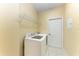 Laundry room featuring a modern washer and dryer set with a shelf and a white door at 12815 24Th Street E Cir, Parrish, FL 34219