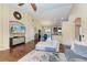 Open-concept living room with vaulted ceiling, wood floors, comfortable seating, and entertainment center at 12815 24Th Street E Cir, Parrish, FL 34219