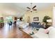 Open-concept living room featuring hardwood floors, vaulted ceilings, and modern furniture for a cozy ambiance at 12815 24Th Street E Cir, Parrish, FL 34219
