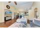 Open-concept living room with vaulted ceiling, wood floors, comfortable seating, and entertainment center at 12815 24Th Street E Cir, Parrish, FL 34219
