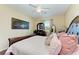 Comfortable main bedroom features hardwood floors, a ceiling fan, and natural light at 12815 24Th Street E Cir, Parrish, FL 34219