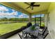 Screened patio with ceiling fan, outdoor dining table set overlooking a beautifully landscaped backyard at 12815 24Th Street E Cir, Parrish, FL 34219