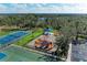Aerial view of the neighborhood playground and tennis court near a lake community at 12815 24Th Street E Cir, Parrish, FL 34219