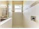 Walk-in shower features tile surround and glass accents at 12815 24Th Street E Cir, Parrish, FL 34219