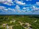 Expansive aerial view of a lush, green landscape under a vibrant sky, dotted with scattered houses at 1375 Norwalk Ter, Port Charlotte, FL 33953