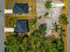 Aerial view of a property showcasing the house layout, surrounding landscape, and outlining property lines at 1375 Norwalk Ter, Port Charlotte, FL 33953