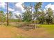 Spacious backyard features a charming garden bed with mature trees, offering privacy and a touch of nature at 1375 Norwalk Ter, Port Charlotte, FL 33953