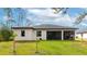 A spacious backyard featuring a covered lanai, perfect for outdoor relaxation and entertaining guests at 1375 Norwalk Ter, Port Charlotte, FL 33953