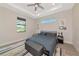 Relaxing bedroom showcasing a plush queen bed, tray ceiling, and natural light from the windows at 1375 Norwalk Ter, Port Charlotte, FL 33953