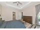 Bright bedroom featuring a tray ceiling, accent rug, and ample natural light at 1375 Norwalk Ter, Port Charlotte, FL 33953
