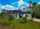 Charming single-story home with a well-manicured lawn and decorative palm trees at 1375 Norwalk Ter, Port Charlotte, FL 33953