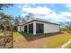 Rear exterior showcasing a screened-in patio and spacious backyard, perfect for outdoor living and entertaining at 1375 Norwalk Ter, Port Charlotte, FL 33953