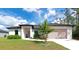 Charming single-story home with neutral paint, complemented by a well-manicured lawn and inviting curb appeal at 1375 Norwalk Ter, Port Charlotte, FL 33953