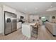 Bright kitchen with large island, modern appliances, and bar stool seating, connects seamlessly to the living area at 1375 Norwalk Ter, Port Charlotte, FL 33953