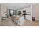 Modern kitchen with a marble island, bar stools, and stainless steel appliances at 1375 Norwalk Ter, Port Charlotte, FL 33953