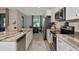 Modern kitchen features stainless steel appliances, granite countertops, and bar stool seating overlooking the breakfast nook at 1375 Norwalk Ter, Port Charlotte, FL 33953