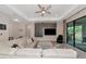 Spacious living room with a sectional sofa, modern entertainment center, and sliding glass doors at 1375 Norwalk Ter, Port Charlotte, FL 33953