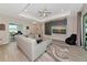 Bright living room features a large sectional sofa, modern ceiling fan and an integrated entertainment center at 1375 Norwalk Ter, Port Charlotte, FL 33953