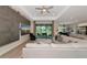 Open-concept living room with a large sofa, mounted TV, and access to the backyard at 1375 Norwalk Ter, Port Charlotte, FL 33953