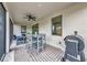 Covered patio with dining and lounge area, offering a relaxing space to enjoy the outdoors and entertain guests at 1375 Norwalk Ter, Port Charlotte, FL 33953