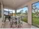 Comfortable screened patio featuring a dining table and BBQ, perfect for enjoying outdoor meals with a view at 1375 Norwalk Ter, Port Charlotte, FL 33953