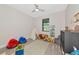 Spacious playroom featuring a modern geometric rug and a variety of fun toys and play structures at 1375 Norwalk Ter, Port Charlotte, FL 33953