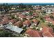A beautiful aerial shot showcasing the red tile roofs and mature landscaping of this charming villa community at 151 Vista Hermosa Cir # 31C, Sarasota, FL 34242