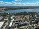 A wide aerial view capturing a dense housing community near expansive waterways and lush greenery at 151 Vista Hermosa Cir # 31C, Sarasota, FL 34242