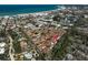 An aerial view shows the community's proximity to the beach and neatly arranged houses at 151 Vista Hermosa Cir # 31C, Sarasota, FL 34242