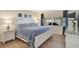 Cozy bedroom featuring light wood floors, a comfortable bed, and a window view at 151 Vista Hermosa Cir # 31C, Sarasota, FL 34242