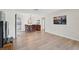 Open dining space with wood-style flooring, seamlessly connected to the living room and kitchen at 151 Vista Hermosa Cir # 31C, Sarasota, FL 34242