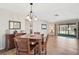 Cozy dining room with wood flooring, a classic chandelier, and easy access to the outdoor patio at 151 Vista Hermosa Cir # 31C, Sarasota, FL 34242