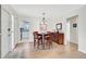 Well-lit dining room with wood floors, a stylish table set, and an open view to the kitchen at 151 Vista Hermosa Cir # 31C, Sarasota, FL 34242