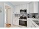 Updated kitchen featuring white cabinets, stainless steel appliances, and a sleek design for a modern touch at 151 Vista Hermosa Cir # 31C, Sarasota, FL 34242